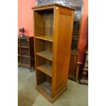 An early 20th Century oak double sided open bookcase