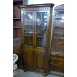 A George III style Ipswich oak freestanding corner cabinet