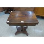 A Victorian rosewood fold over pedestal games table