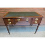 A Victorian mahogany five drawer writing table