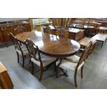 A Regency style mahogany pedestal dining table and six Hepplewhite style chairs