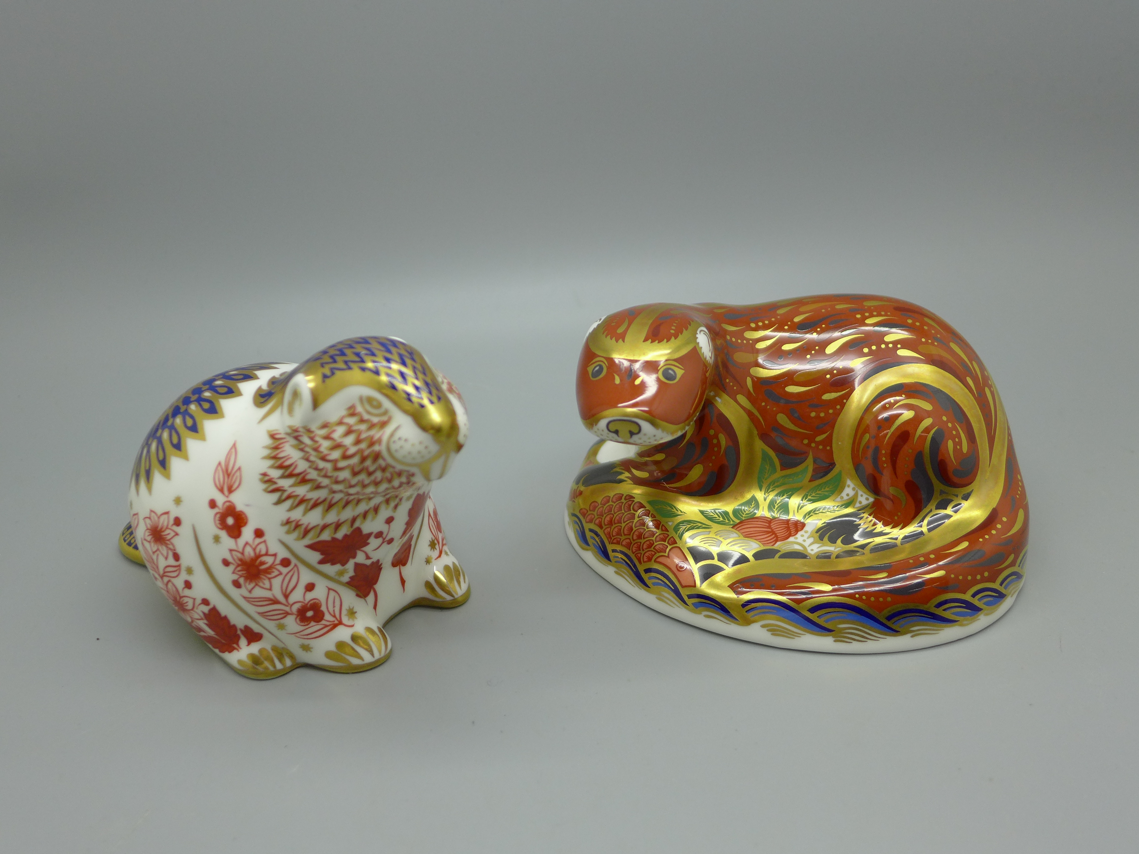 Two Royal Crown Derby paperweights - Otter, a gold signature edition commissioned by The Guild of