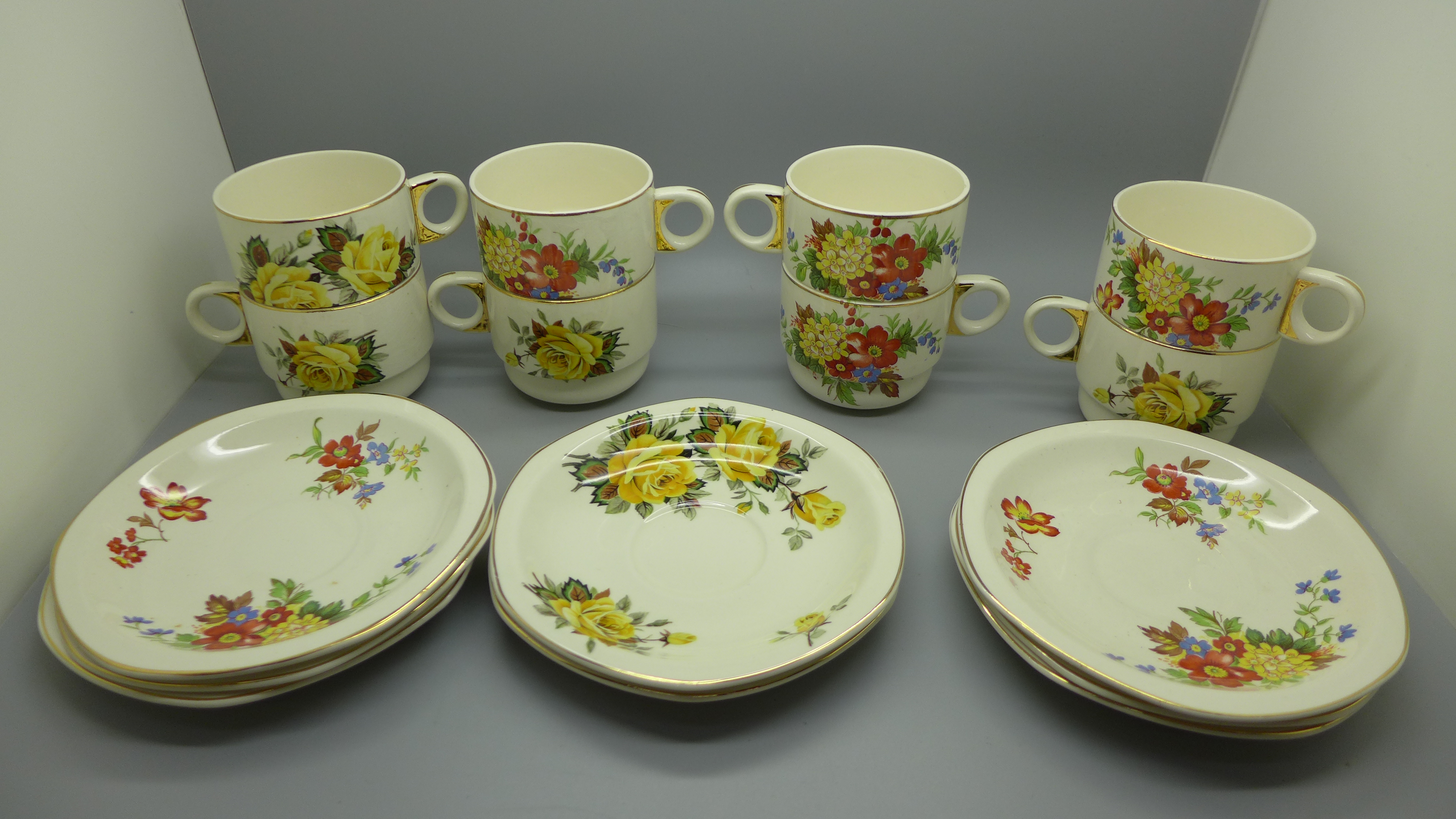 Eight Brexton Pottery cups and saucers decorated with flowers