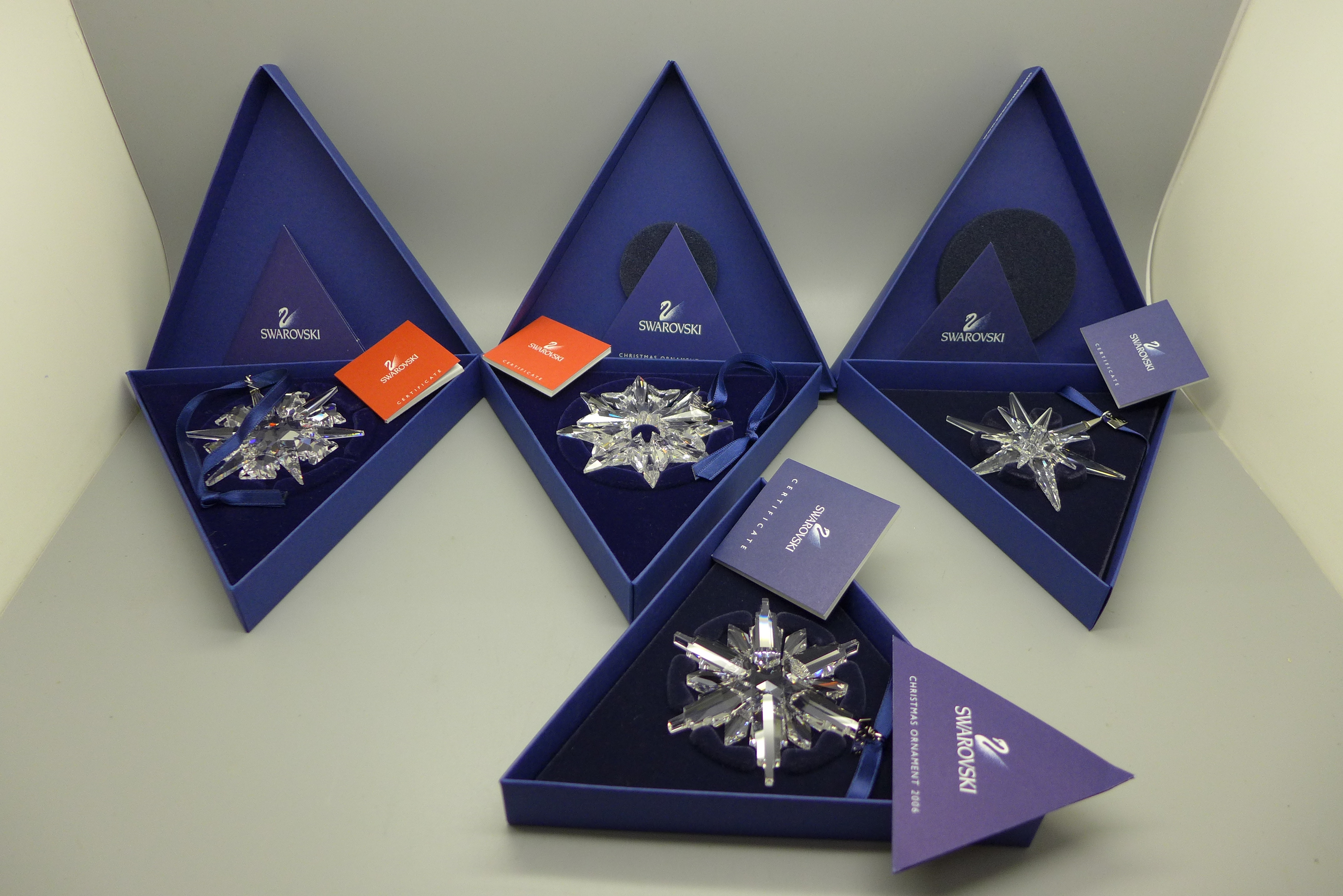 Four Swarovski Christmas ornaments; 2002, 2003, 2005 and 2006