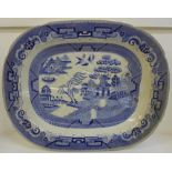 A large blue and white Willow pattern meat plate