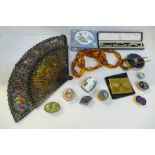 Compacts, an enamel box, a string of amber coloured beads, etc.