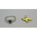A yellow metal camel charm marked 750, 1.1g, and a white metal and blue stone ring marked 18k, 4g, O