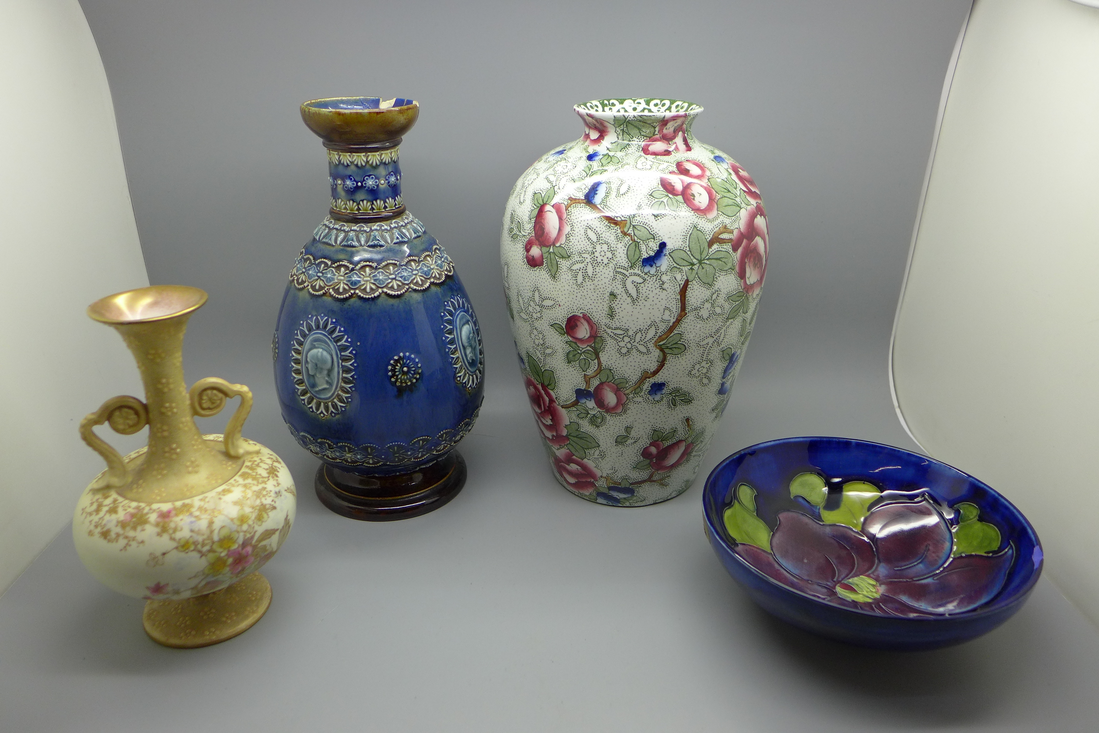 A Doulton Lambeth stoneware vase, a Doulton Burslem vase, a Moorcroft small bowl, all a/f and an