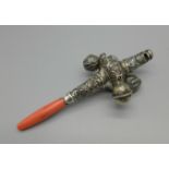 A c1900 rattle/whistle, set with coral, Birmingham mark, lacking one small piece of silver