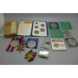 A collection of commemorative coins and WWII medals