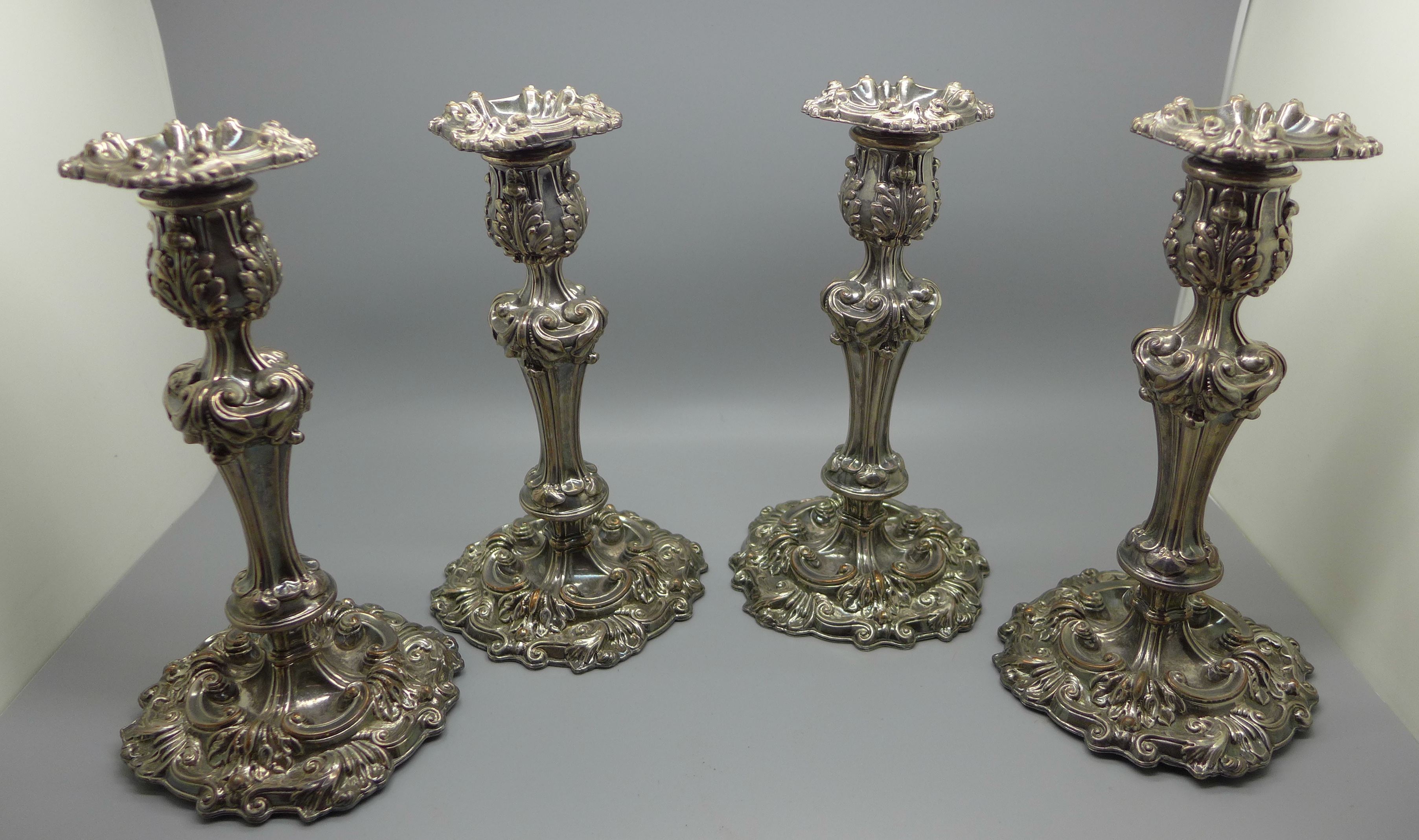 Four matching old Sheffield plate candlesticks with original sconces, circa 1830, 21cm