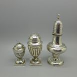 Three silver pepperettes including one Victorian with dented top, 129g