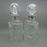 A pair of silver mounted crystal glass decanters