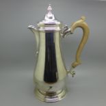 A silver coffee pot with wooden handle, London 1984, 914g, (dent to the side of the base)
