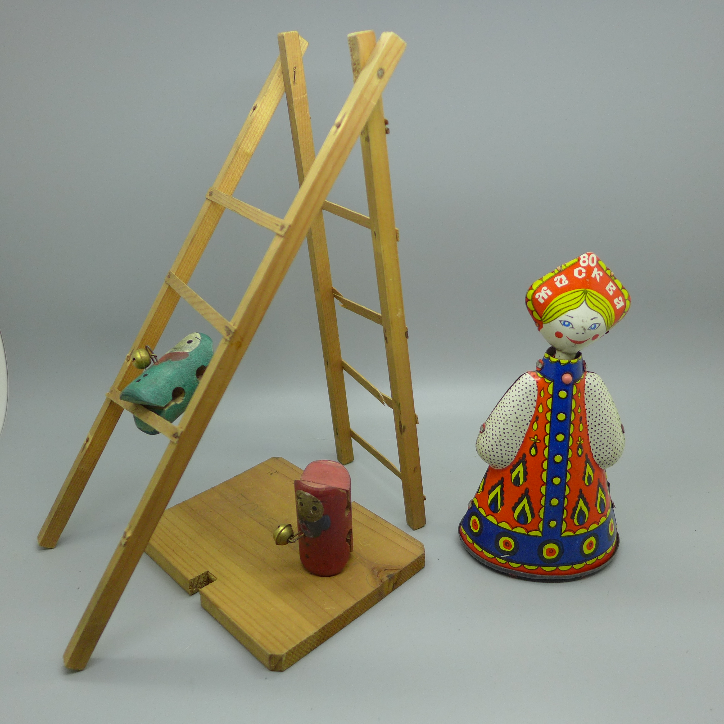 A clockwork Russian doll (no key) and a vintage wooden toy