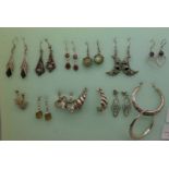 A collection of silver earrings