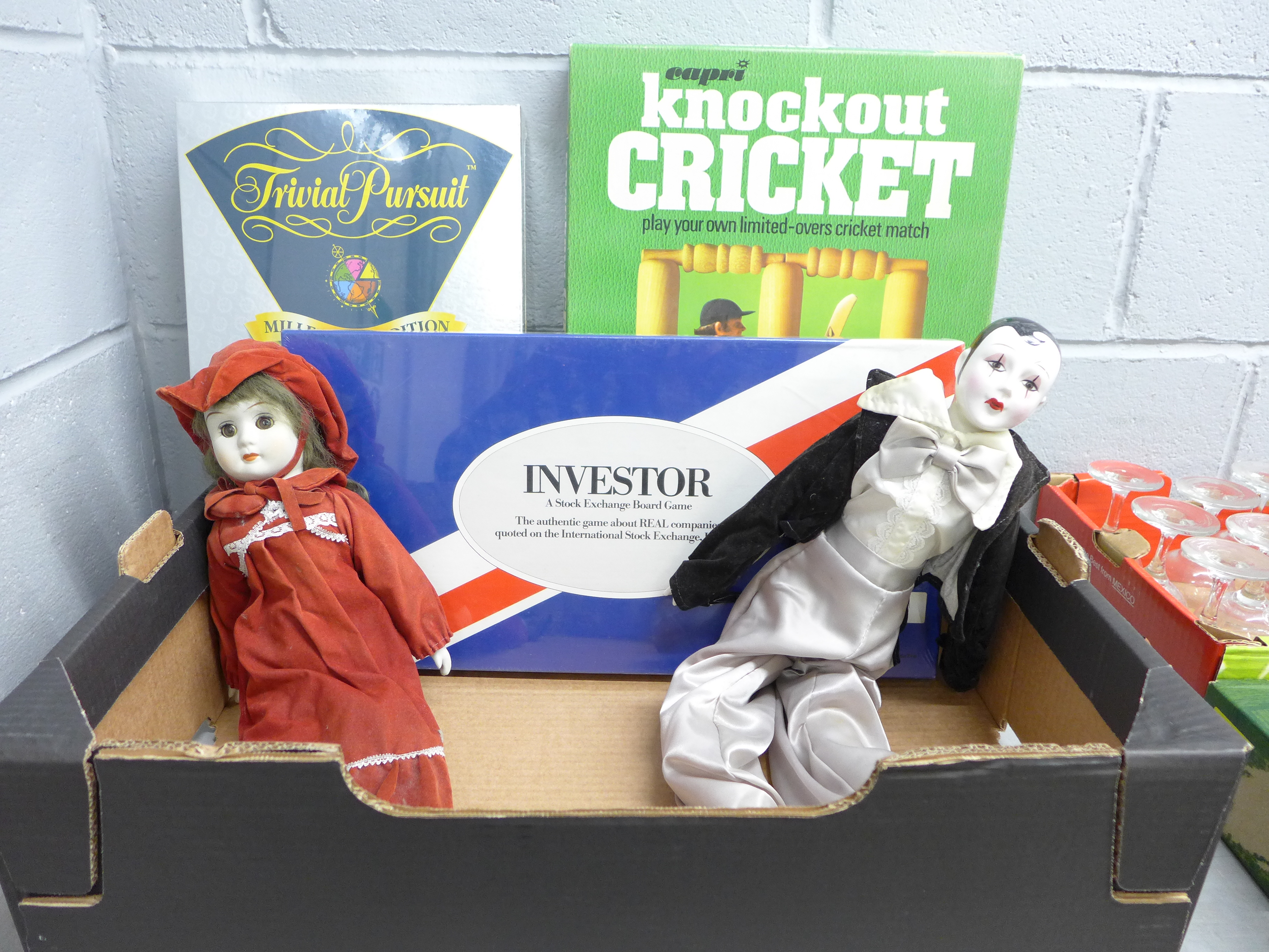 Boxed games; Trivial Pursuit, Knockout Cricket and Investor, a porcelain headed Pierrot and one