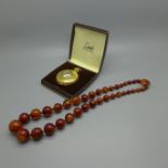 A string of beads and a Limit pocket watch, cased