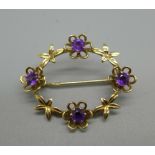 A 9ct gold brooch set with purple stones, 3.5g