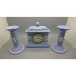 A Wedgwood Jasperware The Dancing Hours clock and a pair of candlesticks