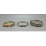 Three silver bangles including one silver gilt set with stones, 89g