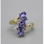 A 925 silver, five stone tanzanite ring with diamond shoulders, L