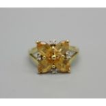 A 9ct gold, spessarite garnet cluster ring with zircon accents, 2.6g, L