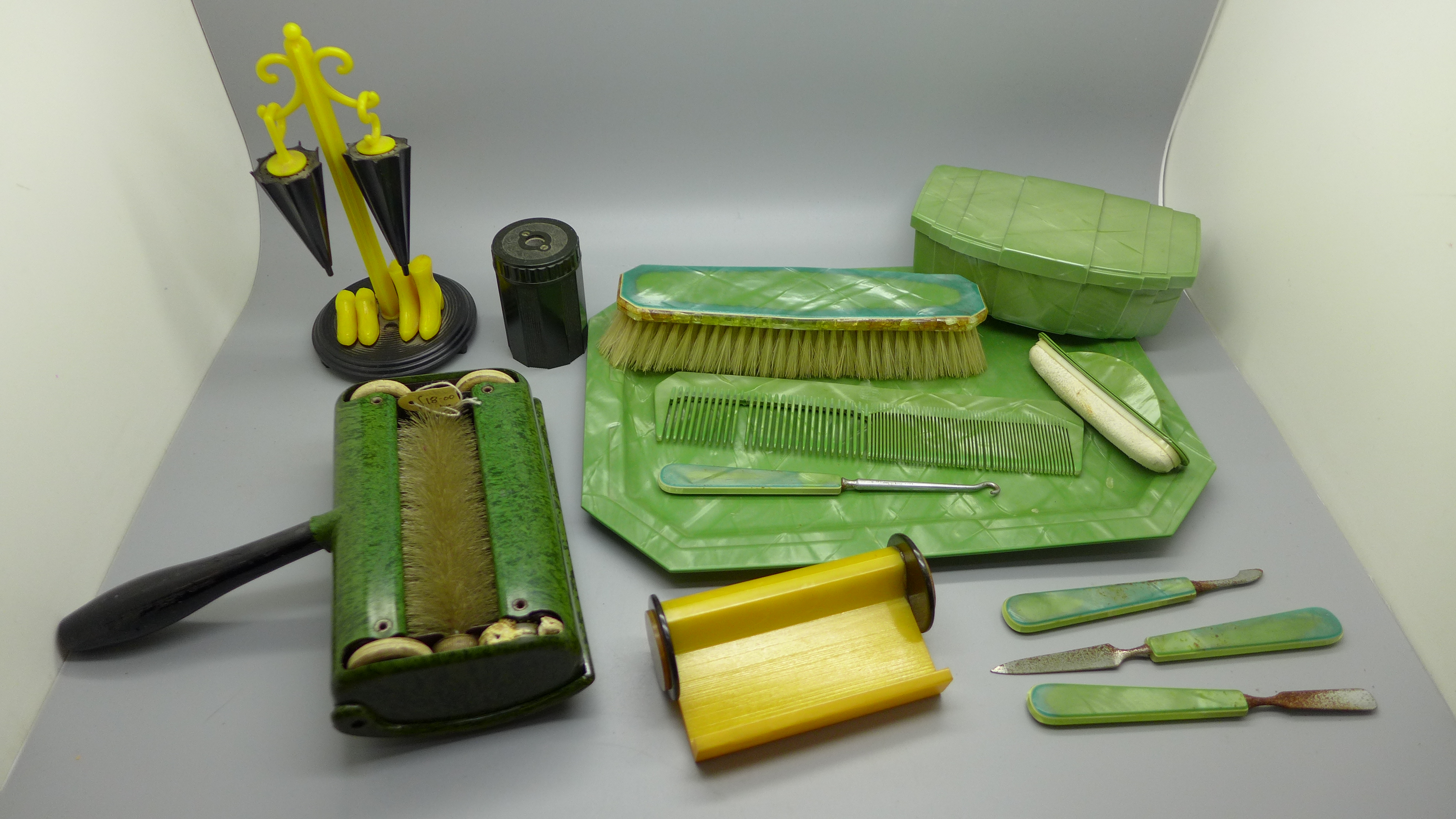 A collection of Bakelite and other early plastic including a card holder, a salt and pepper, a table