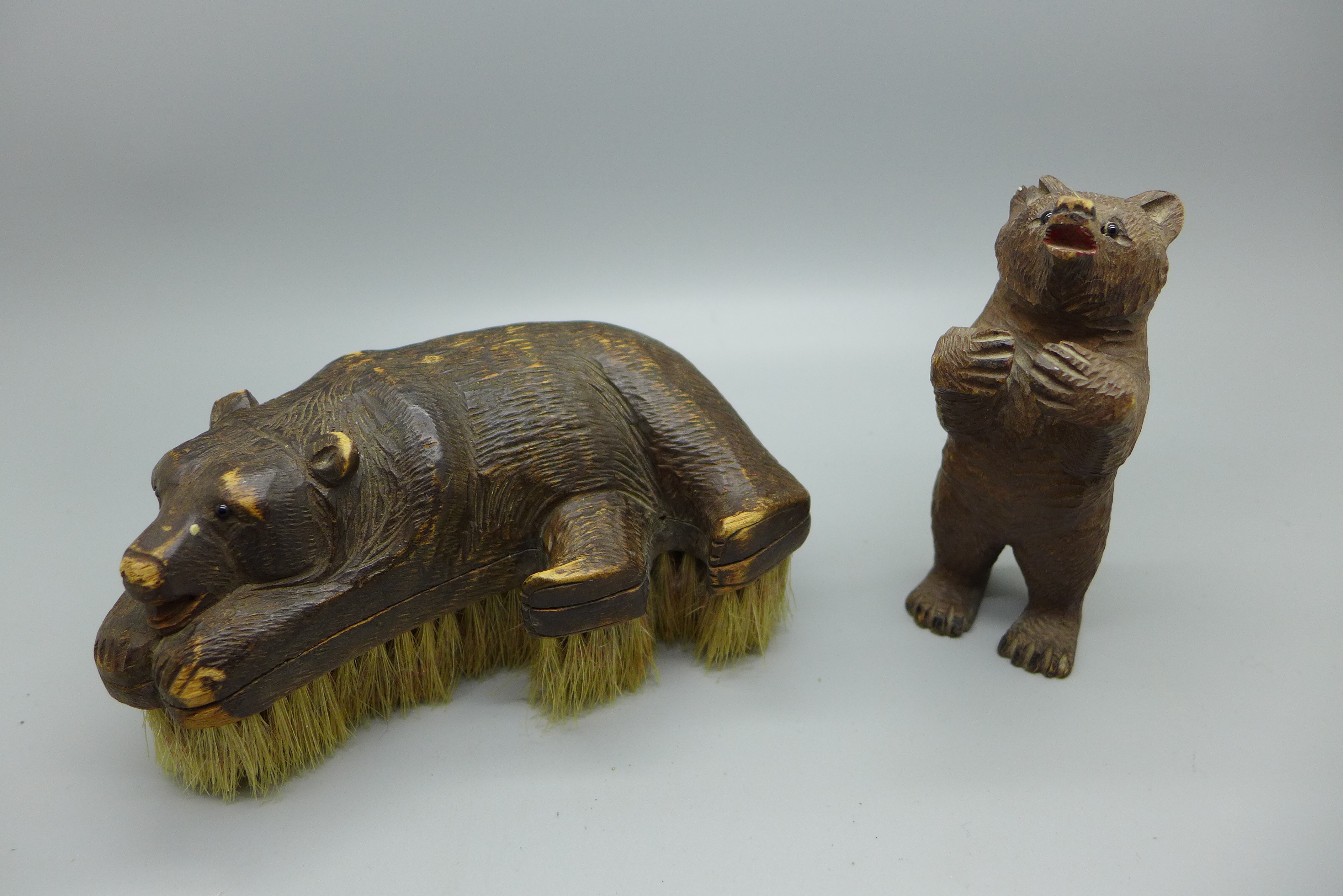 Two carved wooden Black Forest bears, one with brush, both with small losses