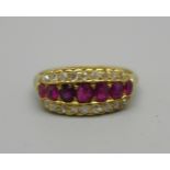 An 18ct gold, ruby and diamond triple row ring, 4.1g, O, one ruby possibly replaced