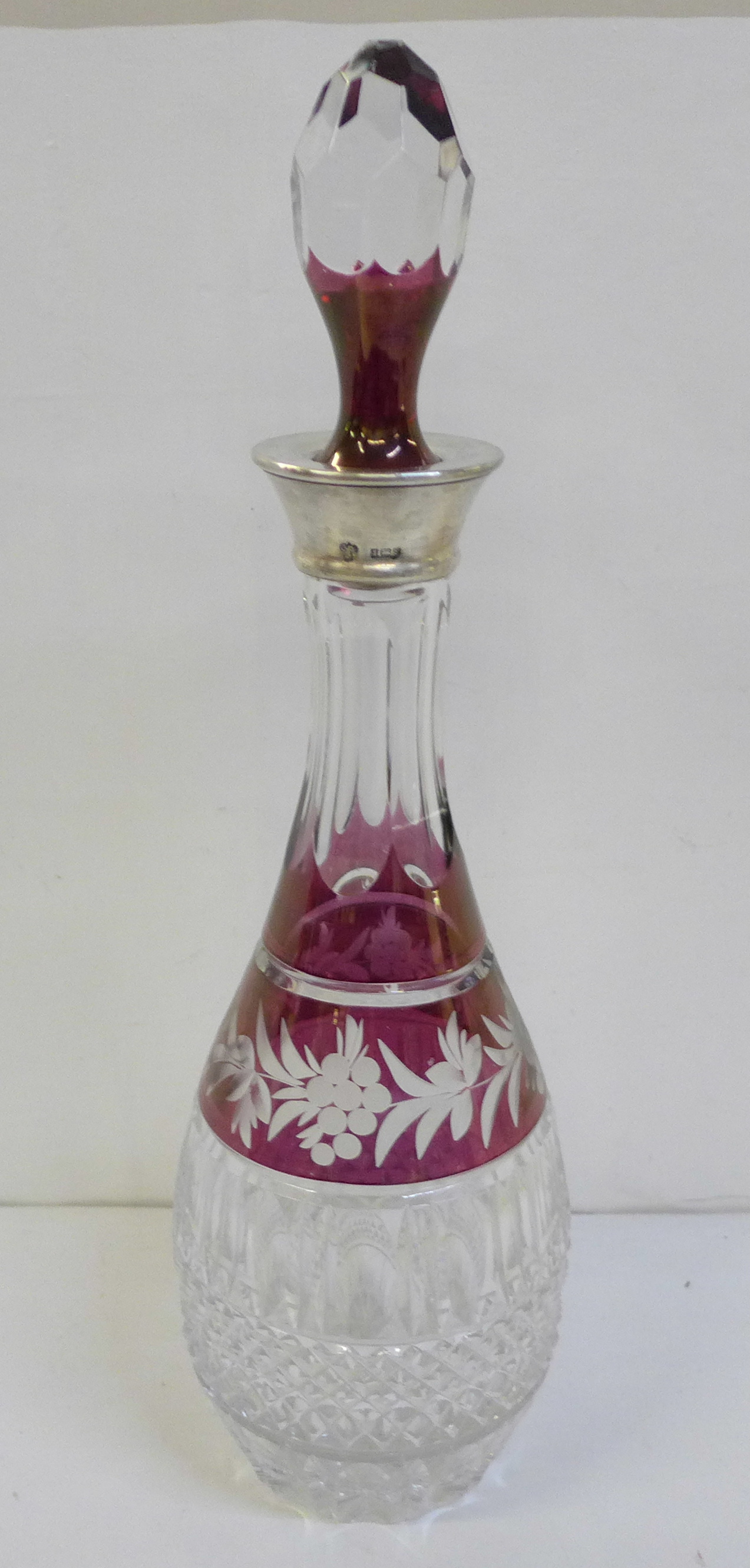 A ruby flash cut crystal decanter with silver top