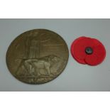A WWI memorial death plaque to George Dickinson, a/f, drilled, with cardboard issue envelope cover