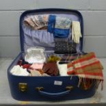 A vintage Antler suitcase with a collection of scarves including one Liberty print, silk and Pringle