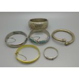 Four silver bangles including one child's, 100g, a white metal bangle and a '9ct gold metal core'