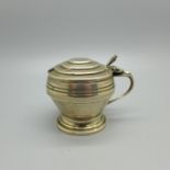 A silver mustard pot with blue glass liner, Walker & Hall, Sheffield 1939, 55g