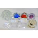 A collection of eight glass paperweights