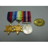 Three WWII medals and a token