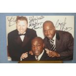 A signed canvas photographic print of Frank Bruno, Nigel Benn and Steve Collins