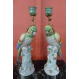 A pair of French style porcelain and gilt metal mounted figural parrot candlesticks