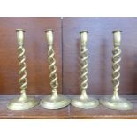 A set of four brass open-twist candlesticks