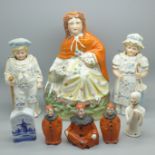 A Staffordshire figure, a novelty Pierrot three piece condiment set, two nodding figures, a pin