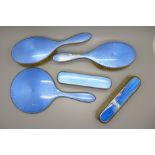 Six pieces of silver and blue enamel; five brushes and a hand mirror, (two brushes and hand mirror