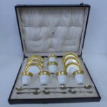 A cased set of six 1920's Royal Worcester coffee cups and saucers with six silver coffee spoons,