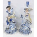 A pair of blue porcelain candlesticks, shepherd and shepherdess, some a/f