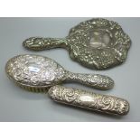 Two silver backed brushes and a hand mirror, a/f