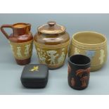 Three Doulton Egyptian Revival pieces of saltglaze pottery, lidded pot, jug and small jardiniere,