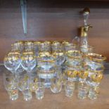 A gold rimmed decanter and gold rimmed glassware, six wines, champagne, other part sets, six beer