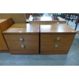 A pair of teak bedside chests