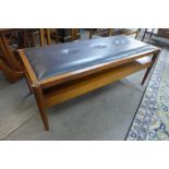 A teak and black vinyl reversible seat/coffee table