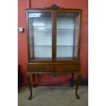 A Queen Anne style walnut two door display cabinet